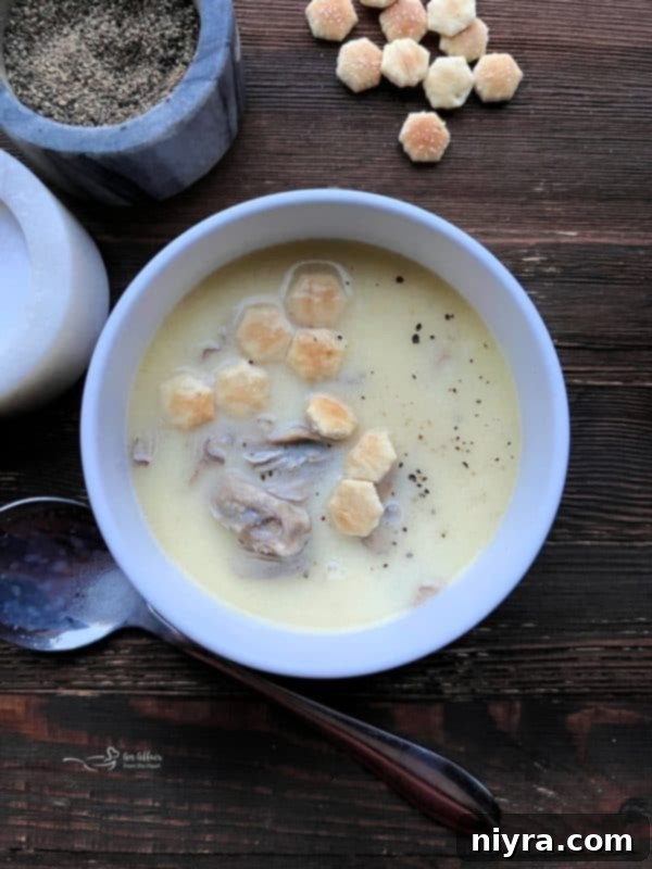 A bowl of creamy oyster stew topped with fresh parsley.