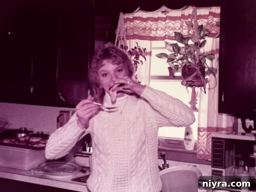 A child eating a raw oyster in a kitchen in 1985.