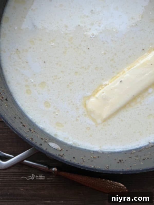 Pouring milk into the oyster stew.