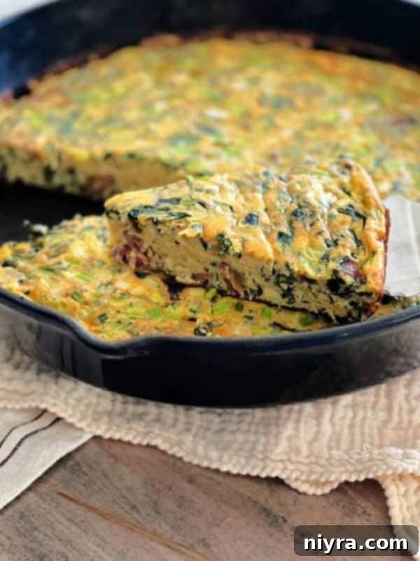 A slice of Bacon and Potato Frittata with fresh herbs on top