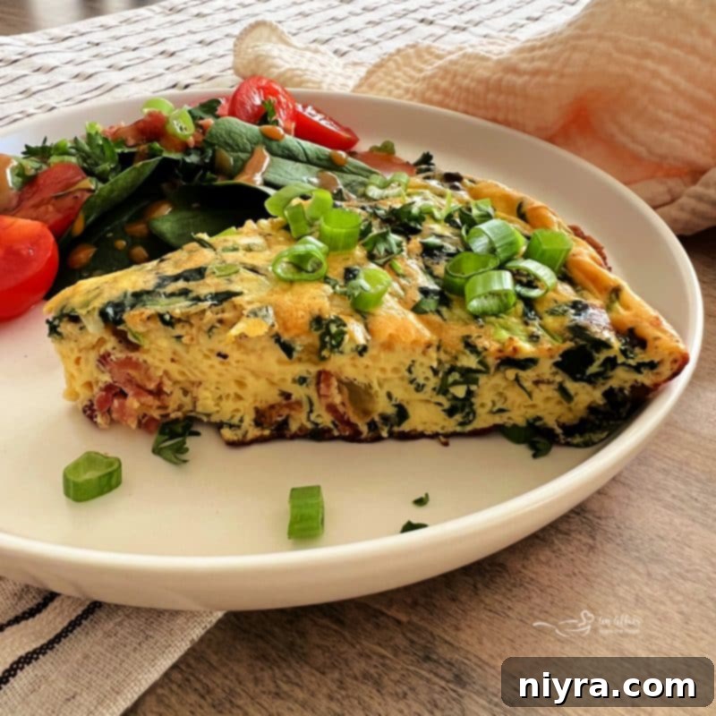 Bacon and Potato Frittata in a cast iron skillet with a wooden spoon