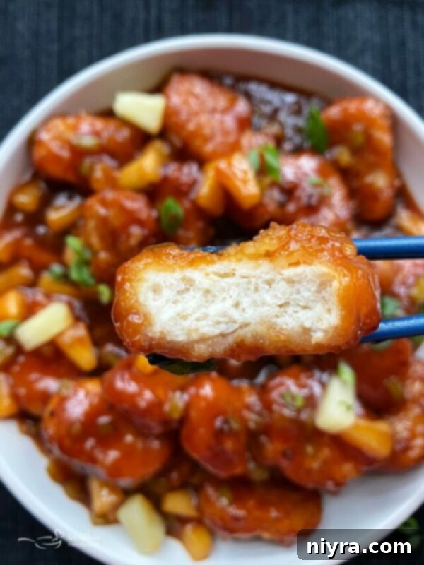 Close up of Sweet and sour chicken with a bite out of it.