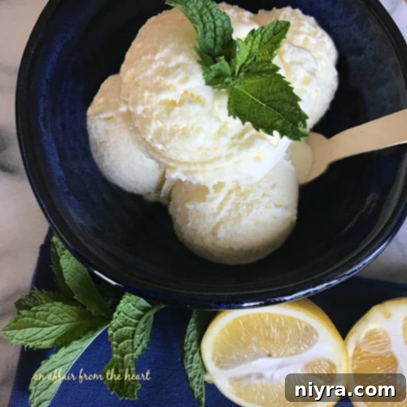 Overhead view of a bowl of lemon ice cream with a spoon, showing its vibrant yellow color and smooth texture.