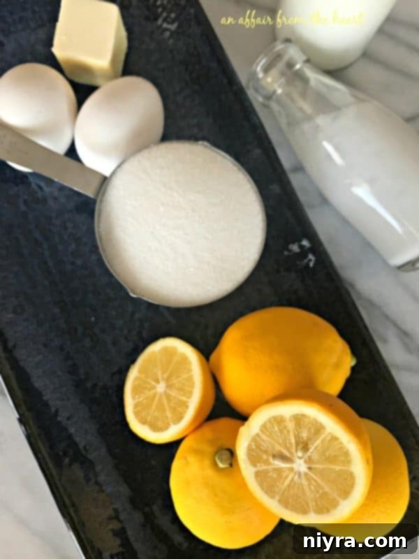 Close-up of fresh lemons, eggs, and a stick of butter, the core ingredients for lemon ice cream.