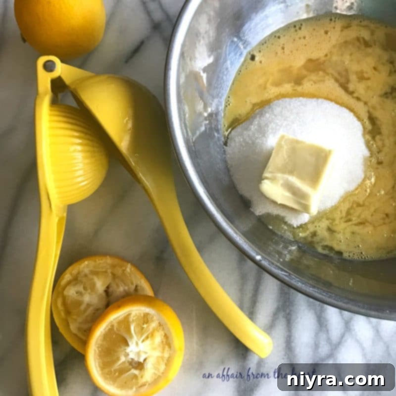 Ingredients for lemon curd in a metal bowl, ready to be cooked over a double boiler.