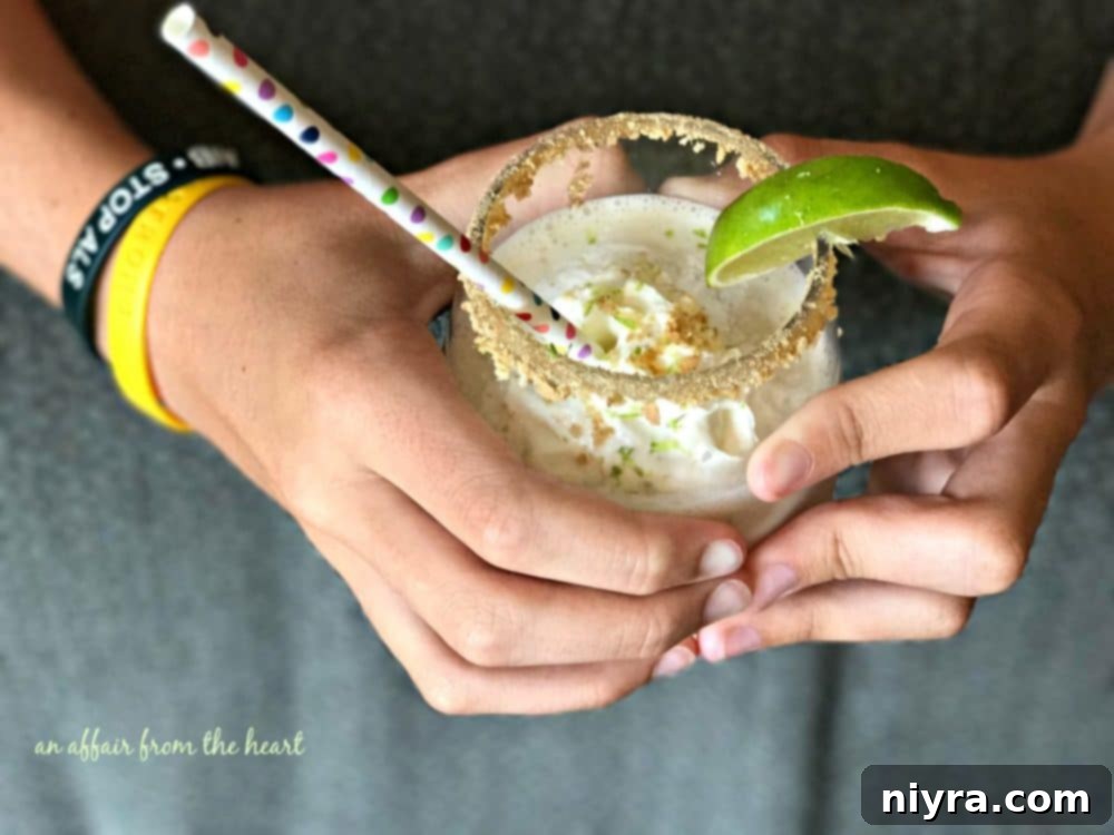 Overhead view of Key Lime Pie Smoothie with lime and whipped cream