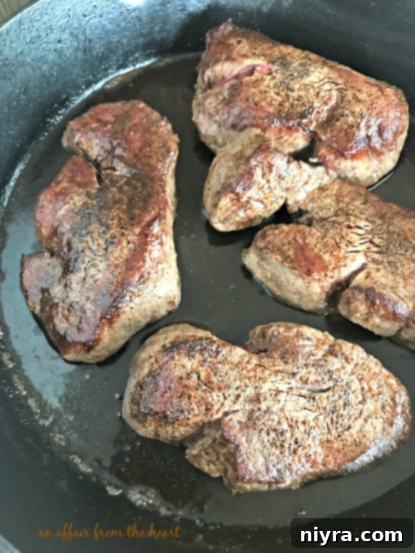 Aromatic Herb Butter Filet Mignon 6 Cooked Filet Mignon steaks resting on a plate, covered with foil, allowing juices to redistribute
