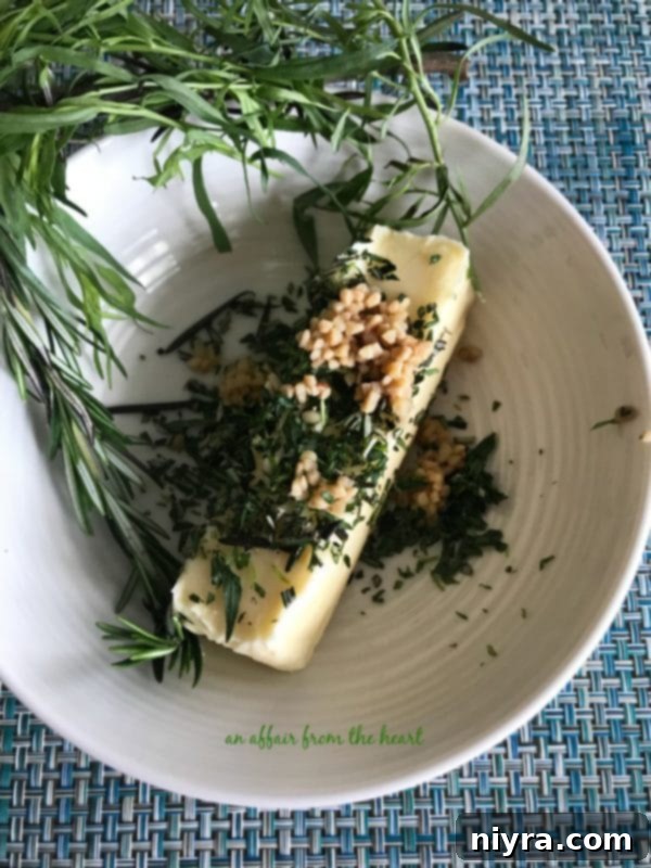 Aromatic Herb Butter Filet Mignon 7 Homemade herb butter on a cutting board, ready to be sliced and served with steak