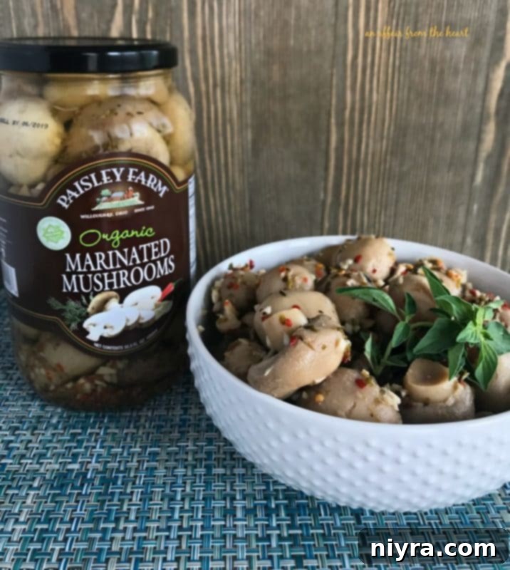 Aromatic Herb Butter Filet Mignon 8 Paisley Farm Organic Marinated Mushrooms in a bowl, a perfect side dish for Filet Mignon