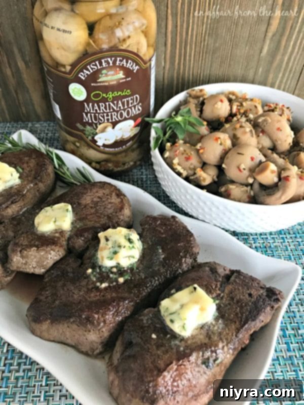 Aromatic Herb Butter Filet Mignon 9 A perfectly cooked Filet Mignon steak topped with herb butter, served with Paisley Farm marinated mushrooms