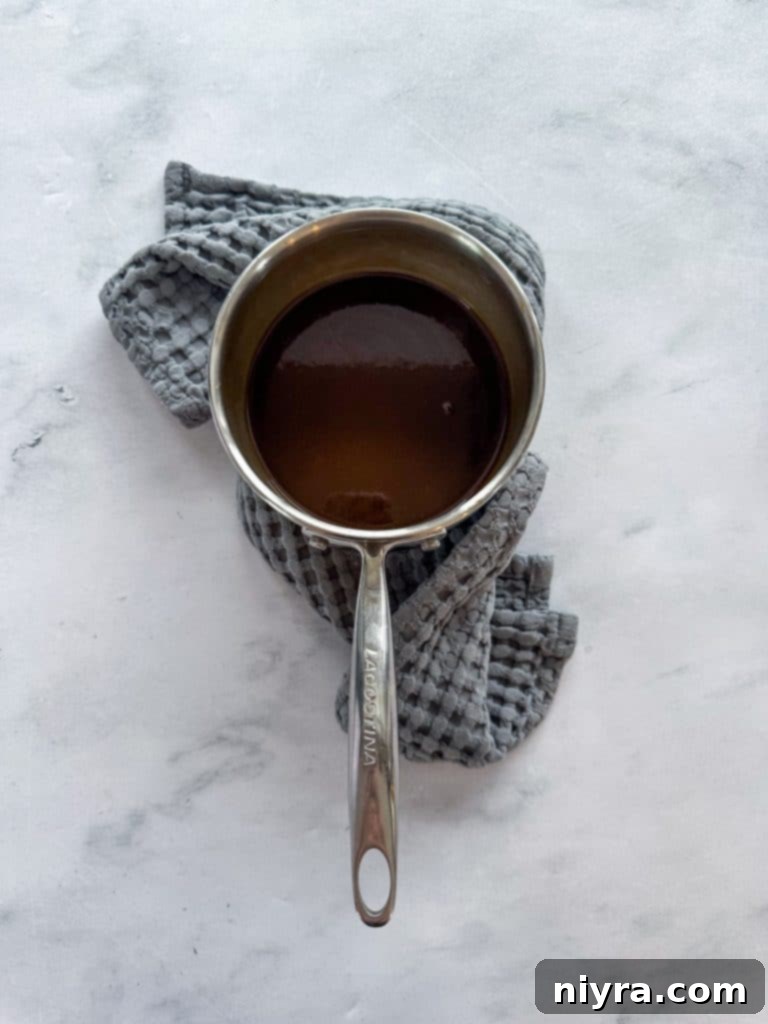 Spiced Rum Caramel Apple Dumplings 13 Spiced rum caramel sauce simmering in a saucepan