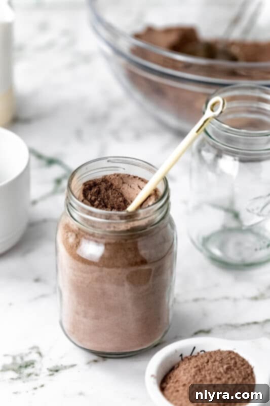 Cozy DIY Hot Chocolate Blend 13 Homemade hot cocoa mix in a jar with a festive ribbon.