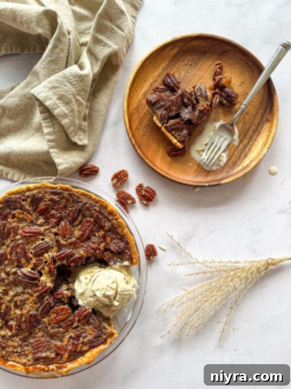 Pecan Pie slice on a plate with ice cream
