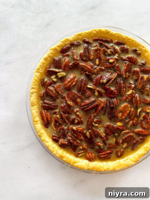 Pecan pie filling in a pie crust before baking