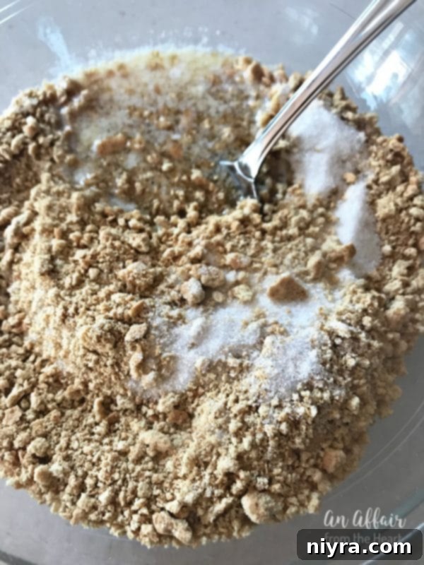 S'mores Brownies 5 Ingredients for graham cracker crust – crushed crackers, melted butter, sugar – being mixed in a bowl