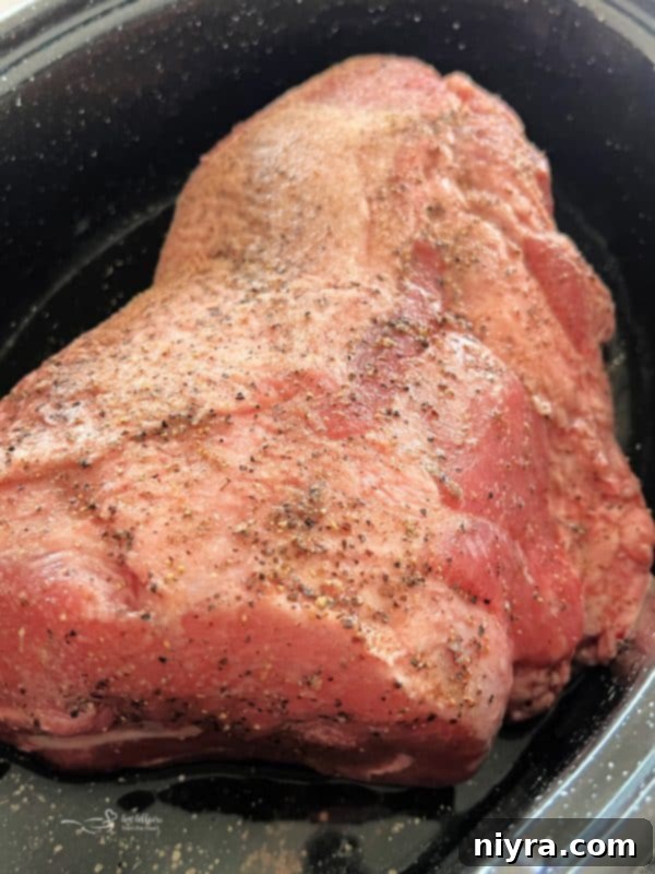 A generous serving of sliced pork roast, drenched in homemade gravy, ready to be enjoyed.