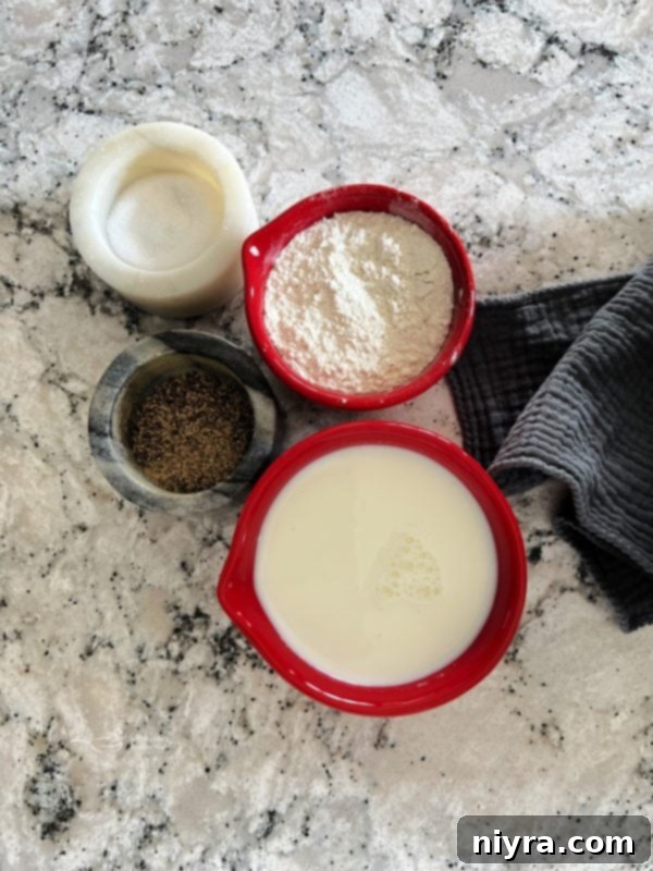 The simple ingredients for pork roast gravy laid out: milk, flour, salt, and pepper.