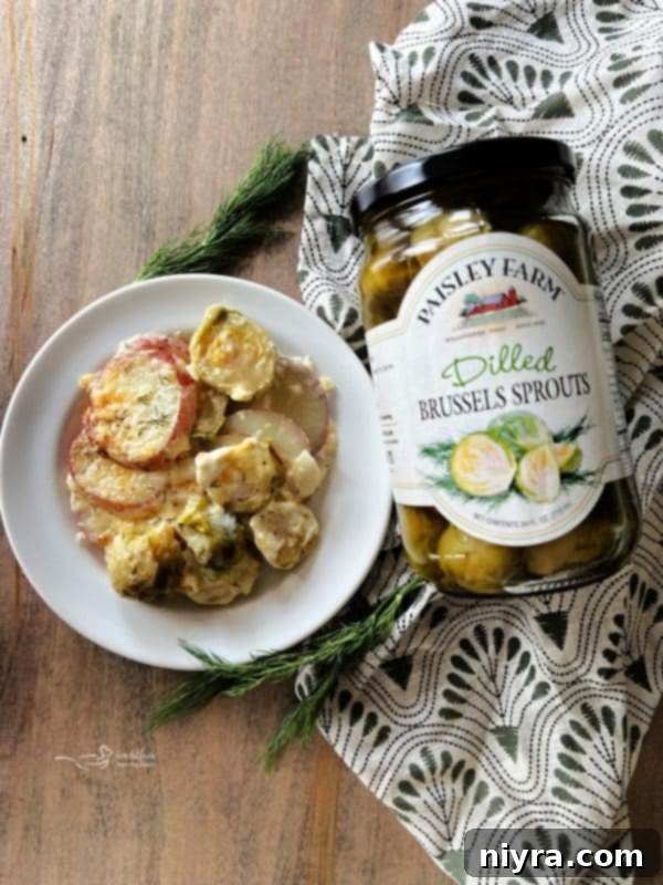 A jar of Paisley Farm Dilled Brussels Sprouts on a wooden surface