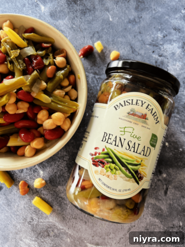 Freshly baked Five Bean and Cheese Enchiladas covered in melted cheese and sauce, ready to serve.