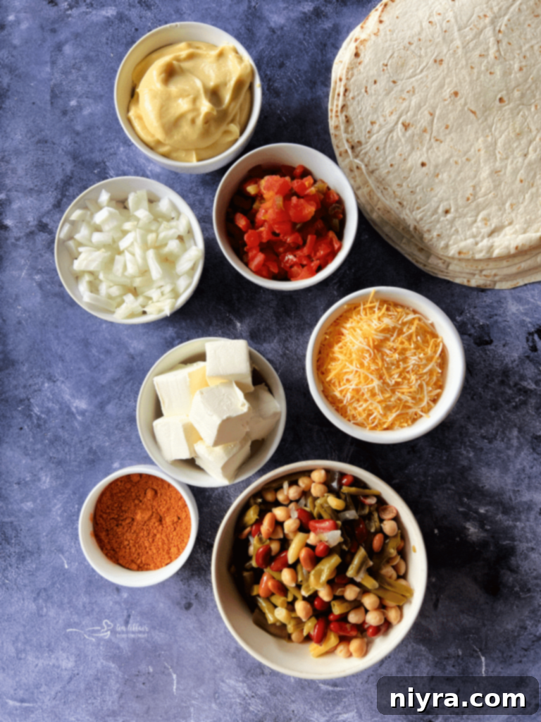 Stack of freshly baked Five Bean and Cheese Enchiladas in a white baking dish.