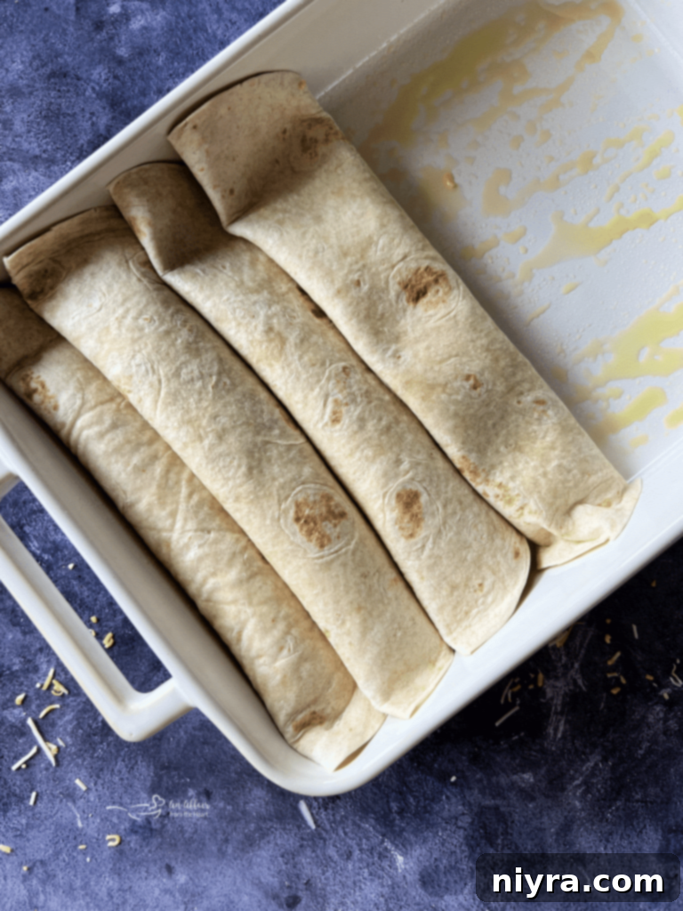 Flour tortillas filled with the bean and cheese mixture, ready to be rolled.