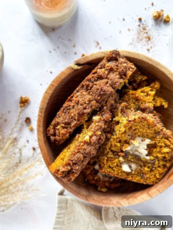 Pumpkin Zucchini Crumble Loaf 2 Moist Pumpkin Zucchini Streusel Bread with crumb topping on a wooden board