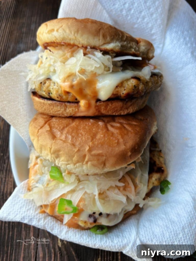 A close-up of a Turkey Reuben Burger showing the vibrant colors of the toppings.