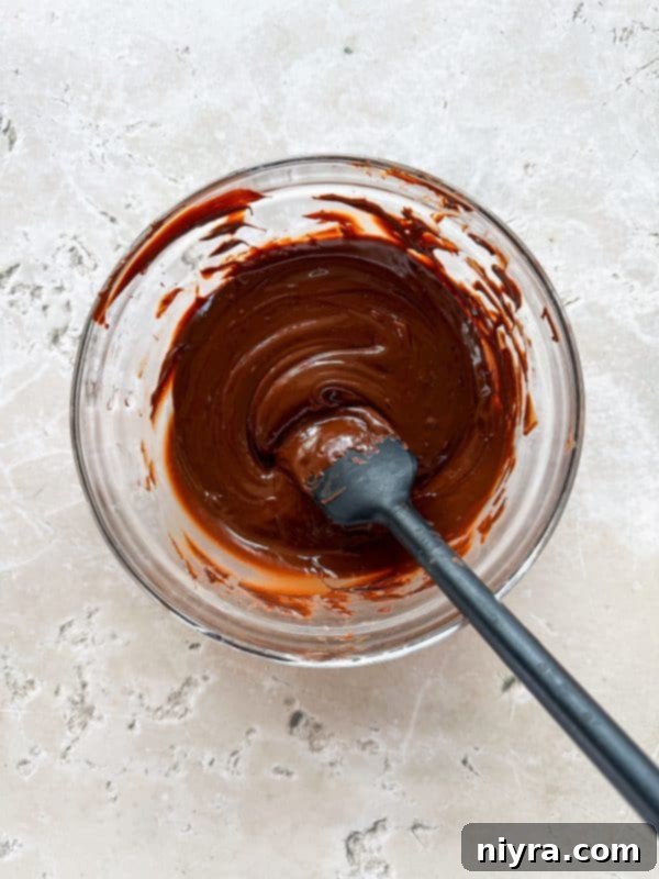 Salted Caramel Chocolate Pretzel Bars 7 Step 1: Lining a cookie sheet with parchment paper and melting chocolate.