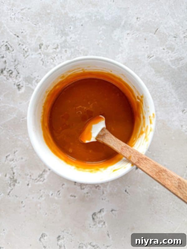 Salted Caramel Chocolate Pretzel Bars 9 Step 4: Pouring melted caramel over the pretzel layer.