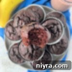 Decadent Chocolate Banana Muffins 3 Close up view of Chocolate Banana muffins stacked on a serving plate.