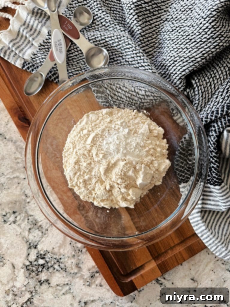 Individual ingredients for self-rising flour laid out: flour, baking powder, and salt.