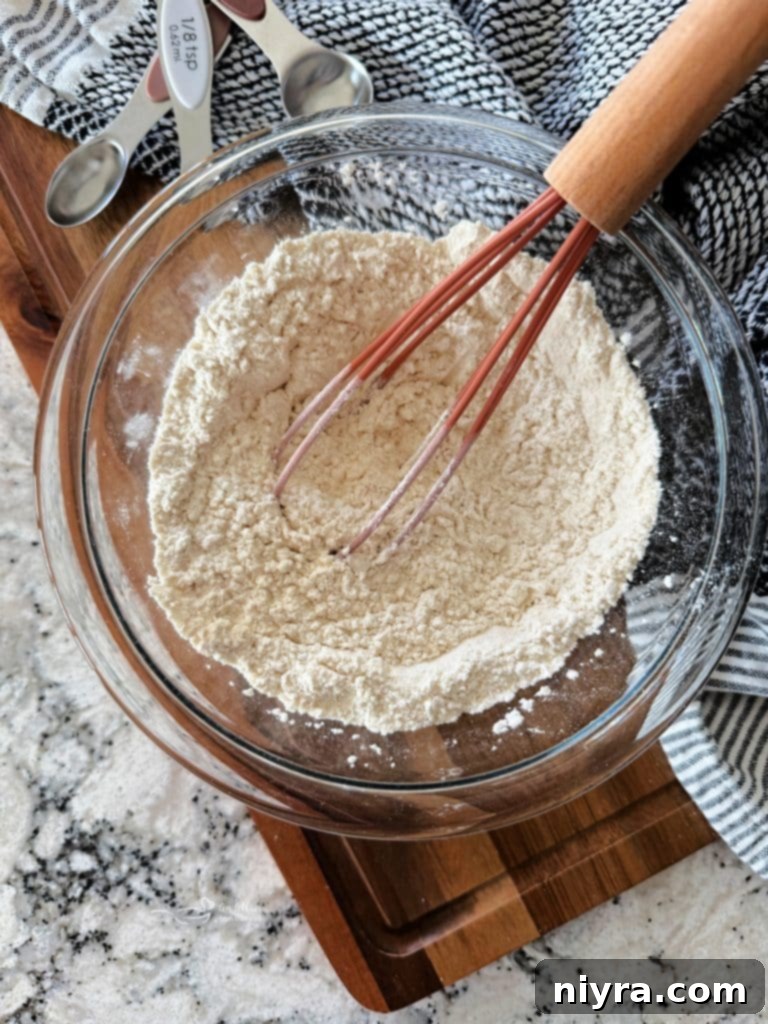 All-purpose flour, baking powder, and salt combined in a bowl, ready to be mixed.
