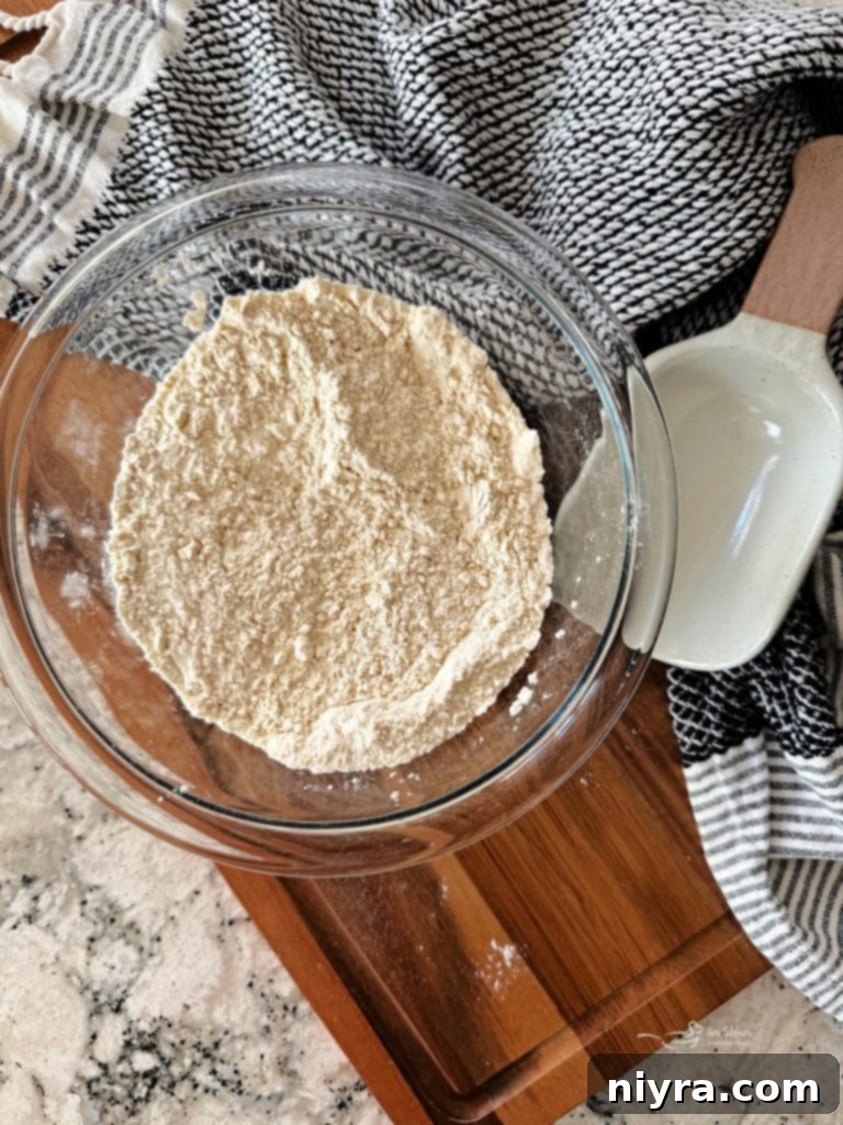 Close-up of homemade self-rising flour with a small scoop, ready for use.