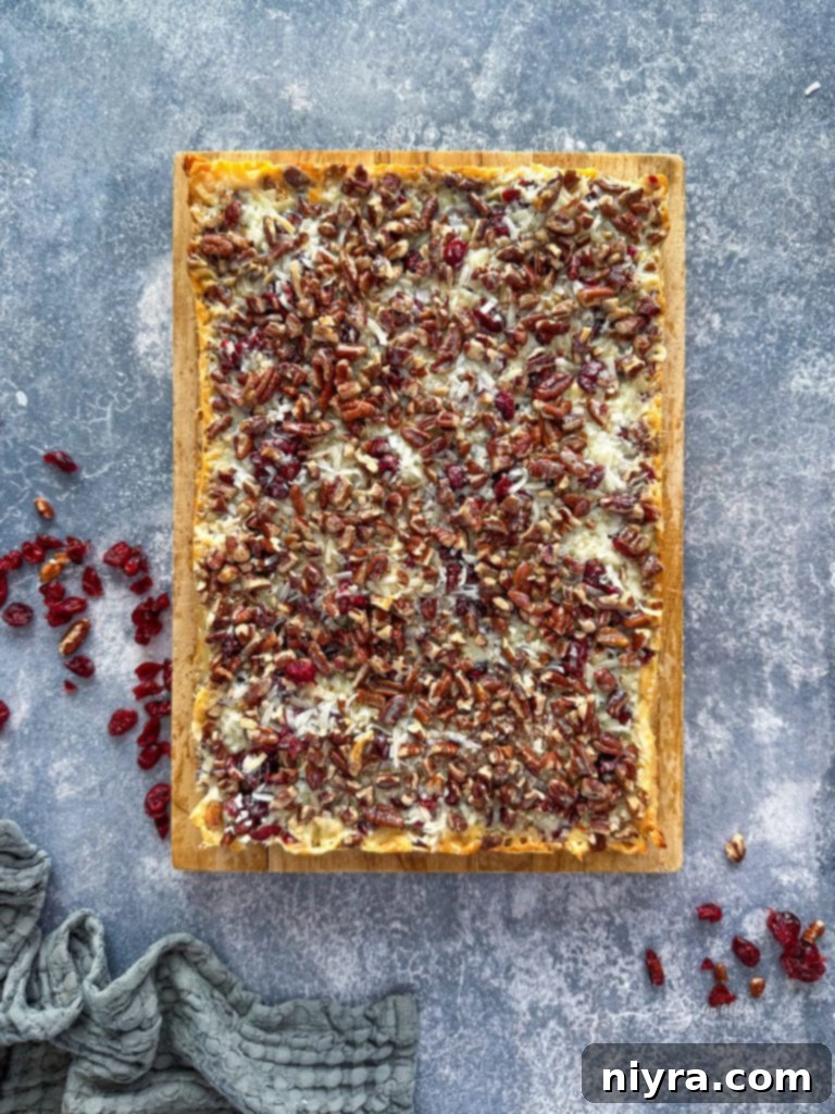 Close-up of a Double Chocolate Cranberry Magic Bar, highlighting the chewy cranberry and chocolate layers