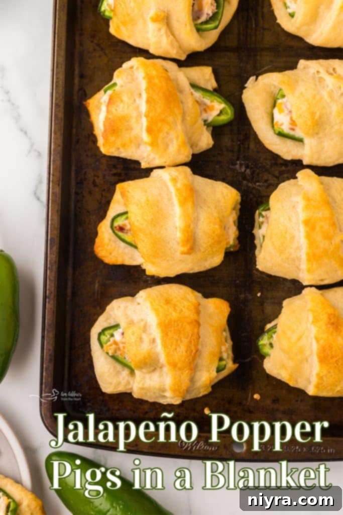 Large serving of Jalapeño Popper Pigs in a Blanket on a wooden board