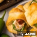 Jalapeño Popper Pigs in a Blanket stacked on a plate