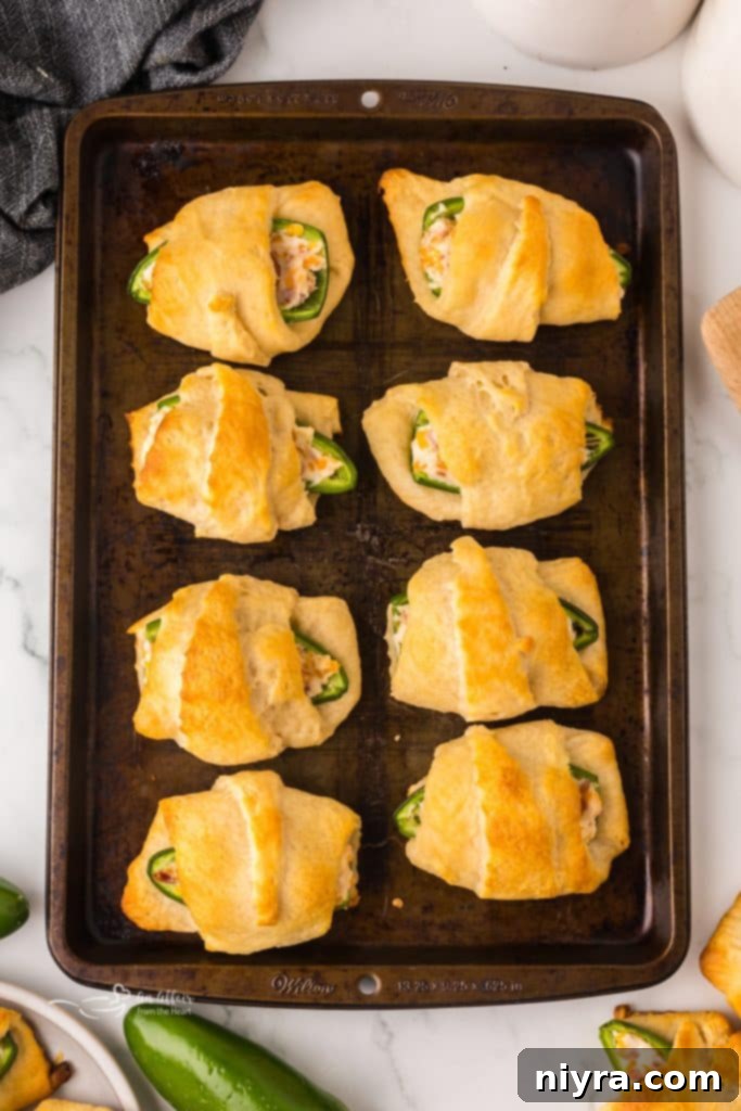 Tray of assembled Jalapeño Popper Pigs in a Blanket, individually wrapped and ready to bake