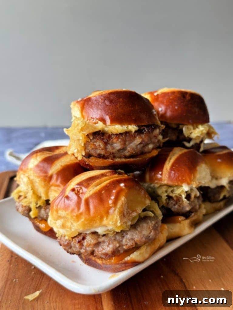 A selection of ready-to-eat Bratwurst Sliders presented on a rustic wooden board.