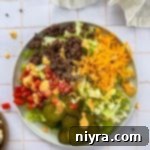 Close up of Big Mac Salad on a white plate.