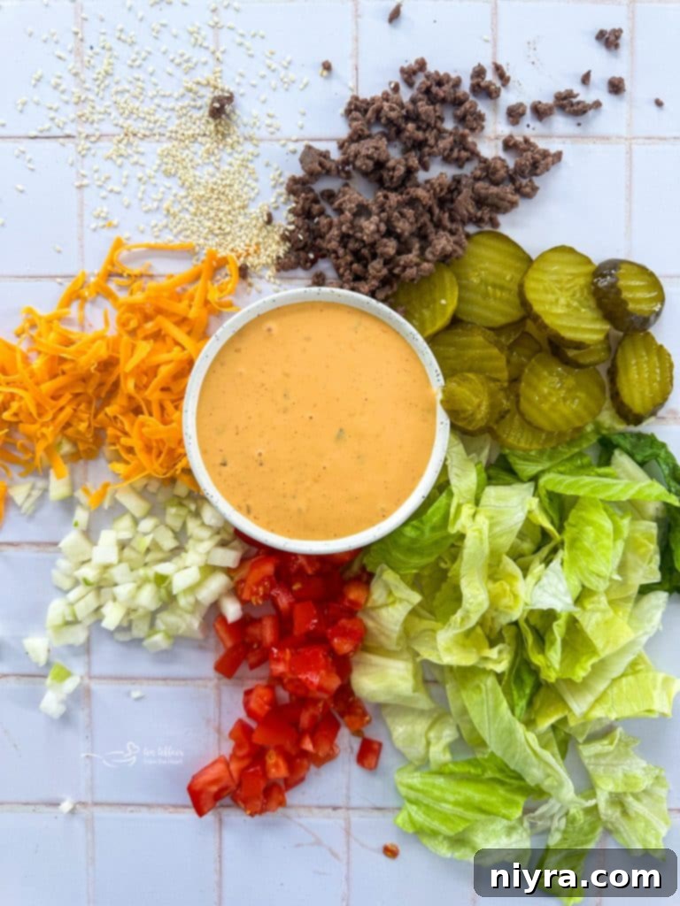 Assembled Big Mac Salad with sauce drizzled over and garnished with sesame seeds.