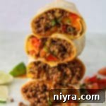 Close up of Copy Cat Taco Bell Meximelts stacked on a light surface.