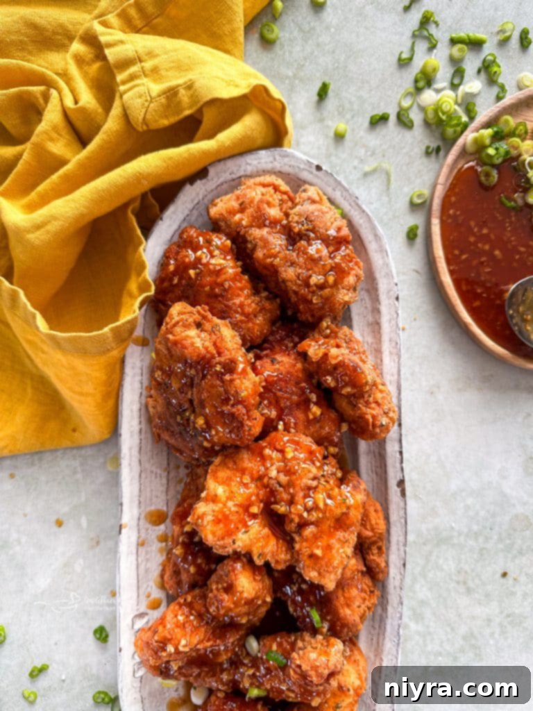 Fiery Honey Crispy Chicken Bites 12 Close up of crispy Honey chicken on a white serving platter.
