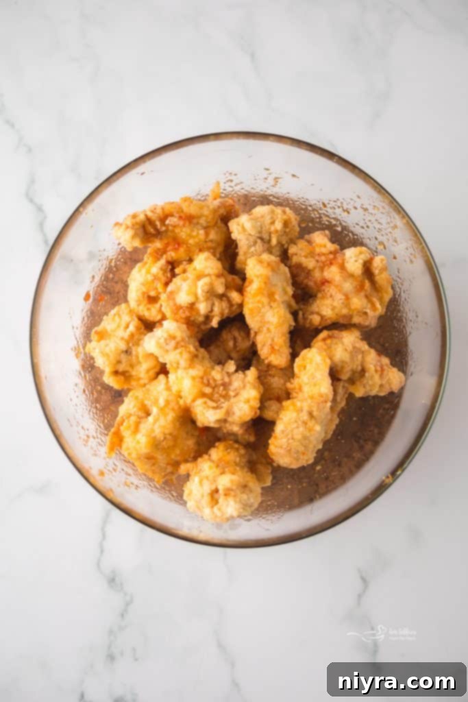 Fiery Honey Crispy Chicken Bites 8 Frying popcorn chicken in hot oil.