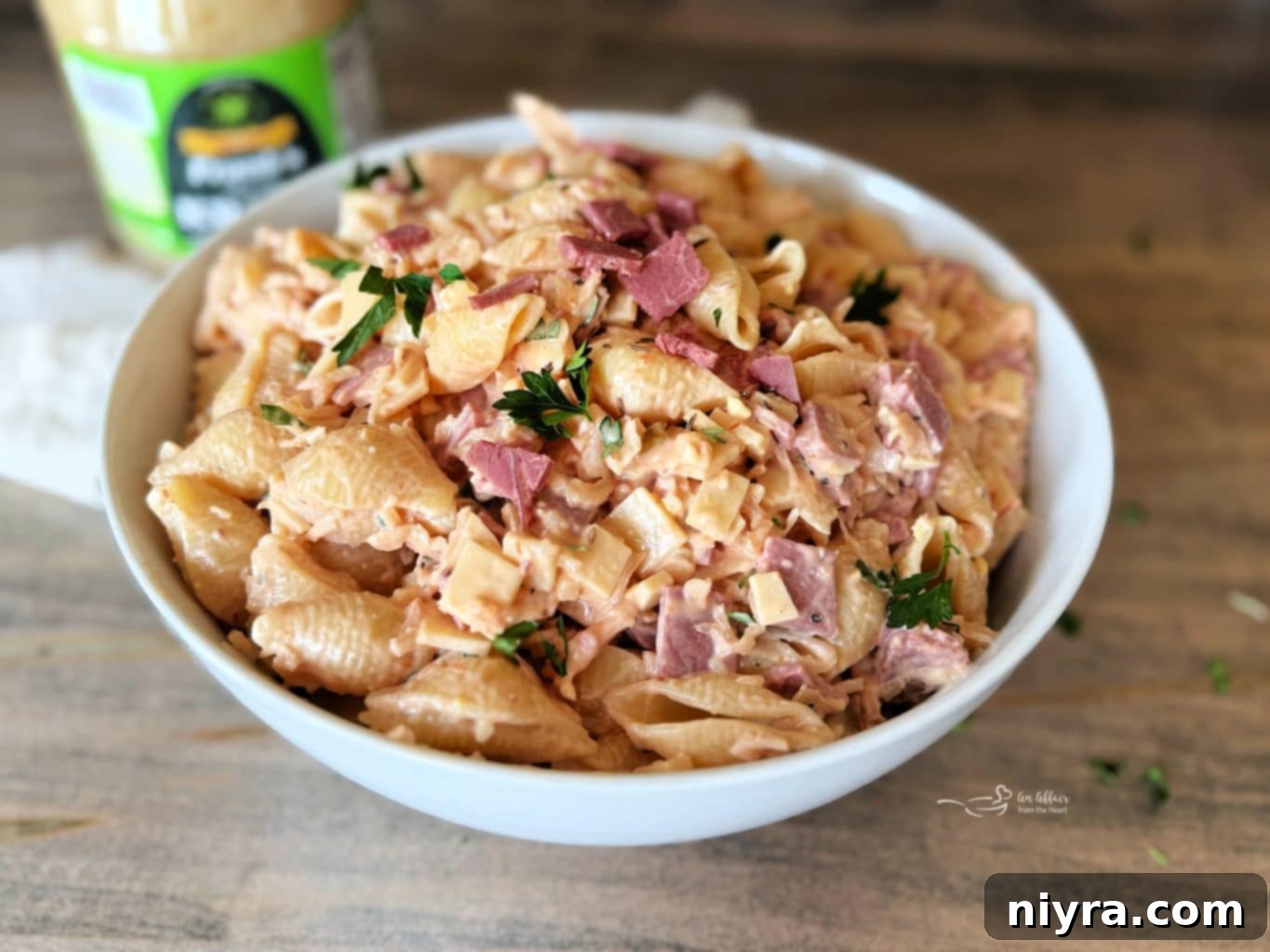 Close-up of Reuben Pasta Salad in a white bowl with a fork