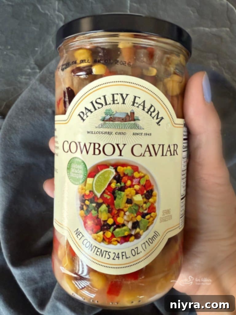 Paisley Farm Cowboy Caviar jar with a serving spoon.