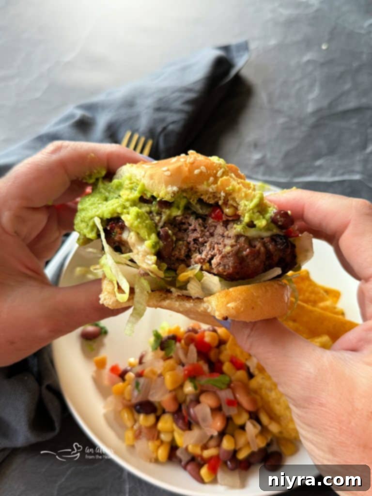 Close-up of a Mexican Hamburger showing the patty and melted cheese.