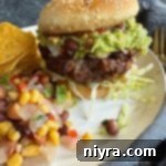 Side view of Mexican Hamburgers on a white plate.