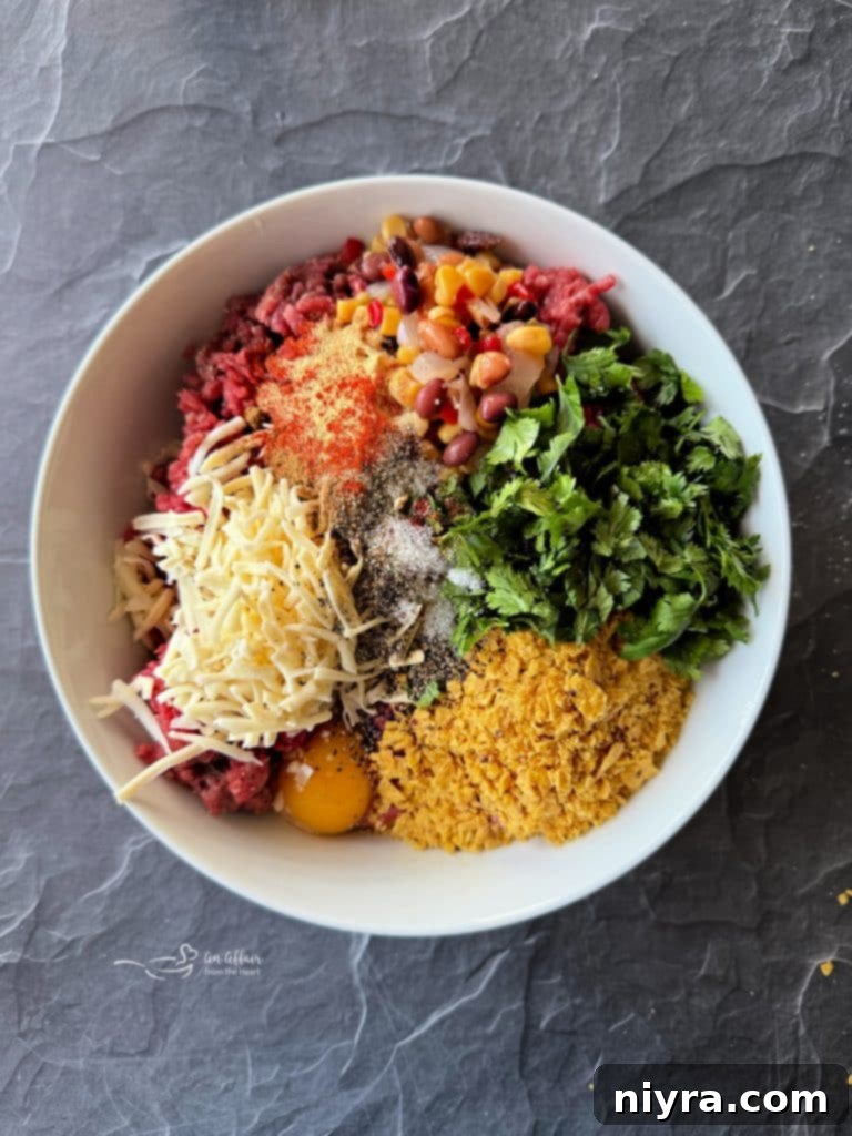 Mixing ground beef with ingredients for Mexican Hamburgers.
