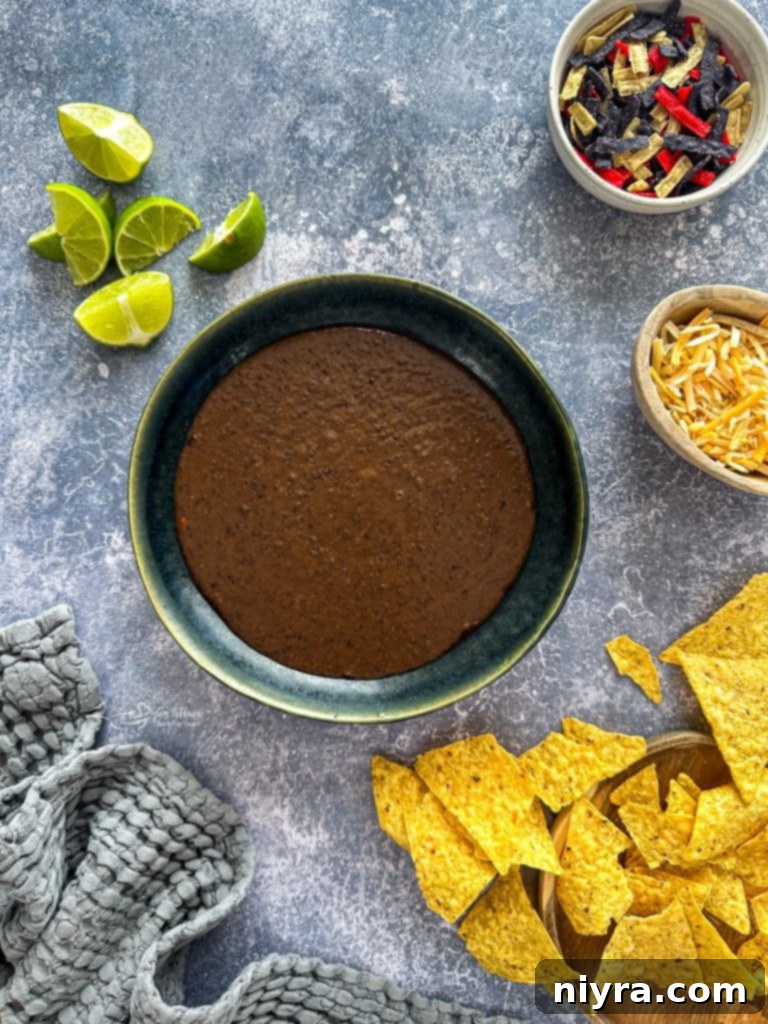 A serving of black bean soup, garnished and ready to eat.