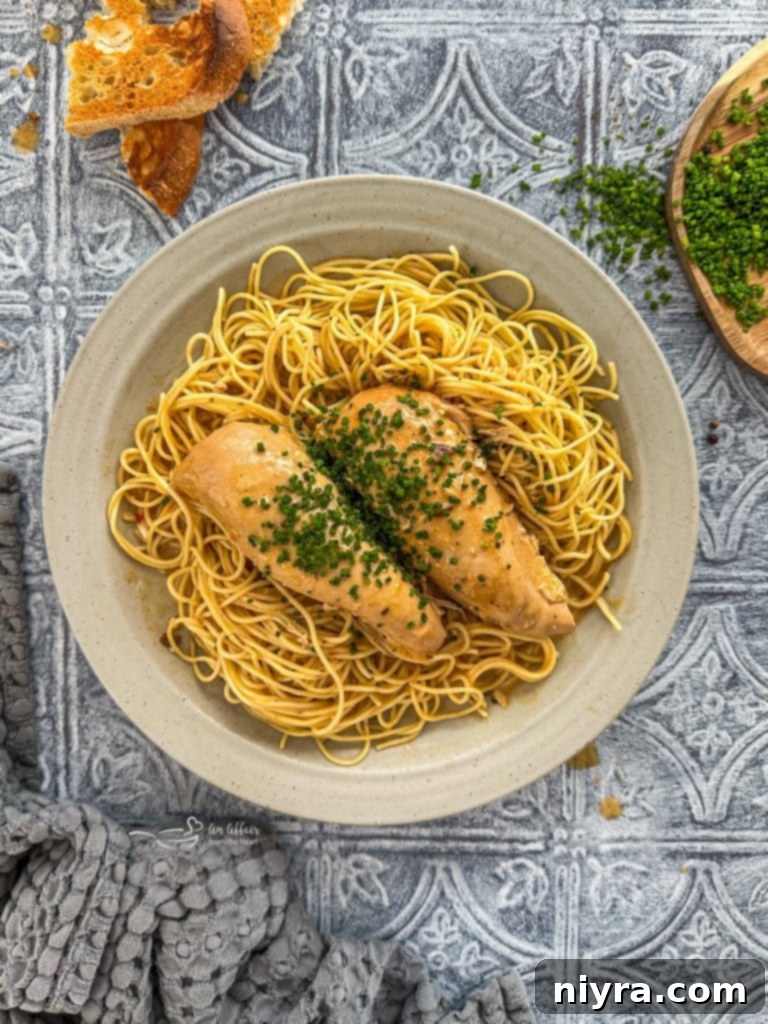 Close-up of creamy Slow Cooker Angel Chicken in a crockpot, ready to be served.